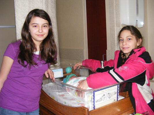 Malia and Andrea visit the baby.
