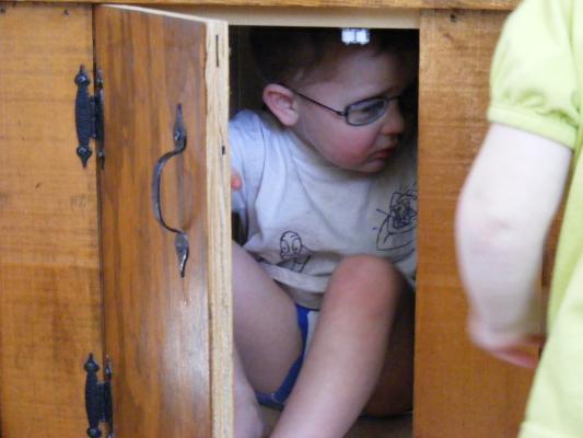 Noah under the fishtank.