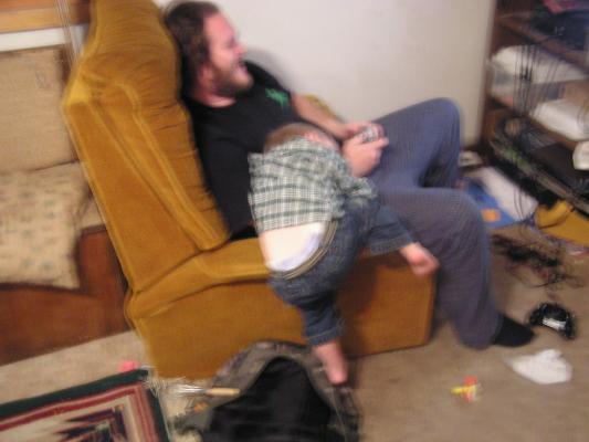 Noah fell asleep wathcing Benji play video games.