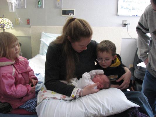Noah looks at the baby.