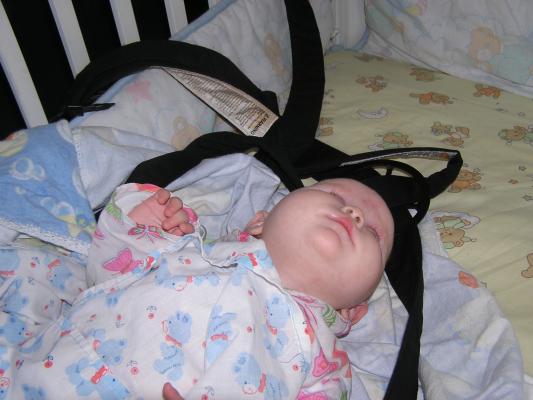 Sarah in her crib in her carier.