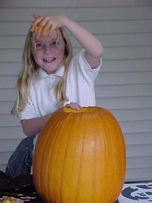 Stephanie carving a pumkin