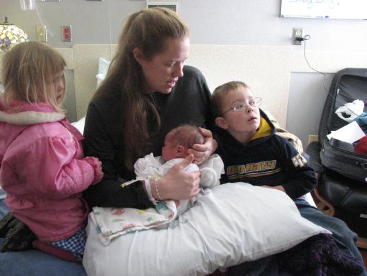 Sarah, Joshua and Noah on the bed at the hospital.