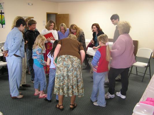 Everyone stands around memorizing all of the baby items.