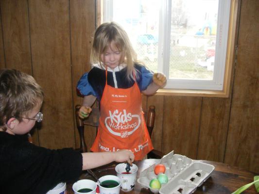 Noah and Sarah dying eggs.