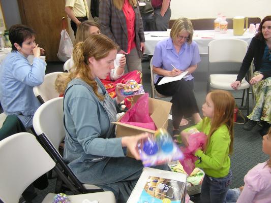 Katie opens presents at Sarah's baby shower.