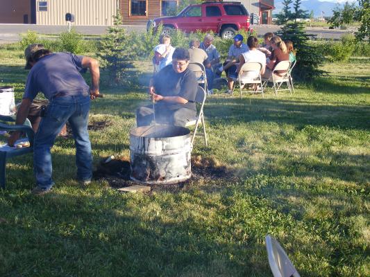 Vonnie cooks with stick.