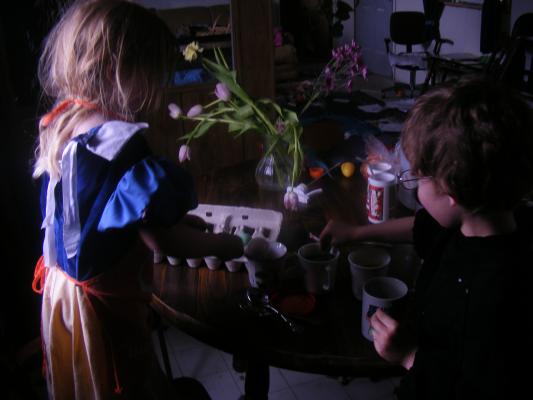 Sarah and Noah dying eggs.