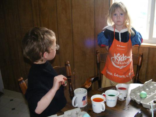 Noah and Sarah dying eggs.