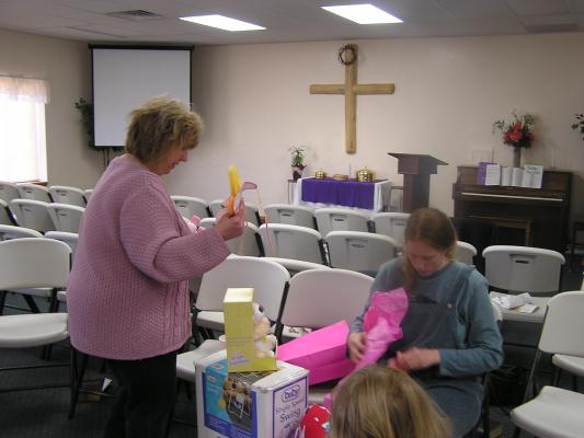 Kim brings over the props from the memory game.
