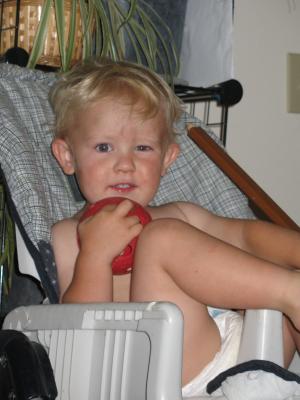 Noah sits in a high chair.