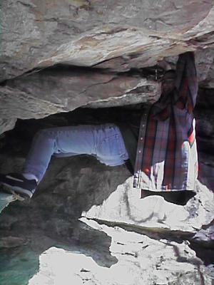 Jim hangs from a rock.