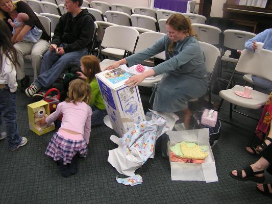 Katie looks at the baby swing box.