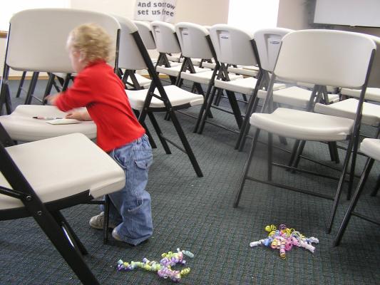 Noah plays with the chairs.