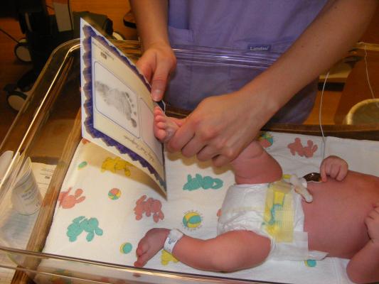 Joshua get his footprints taken.