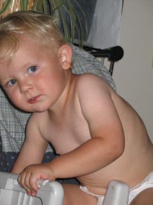 Noah sits in a high chair.