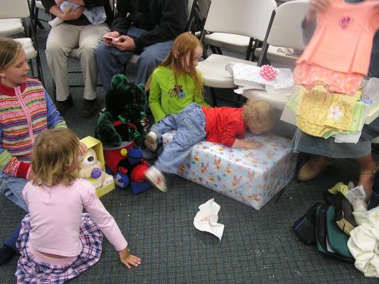 Noah decides it's fun to climb on the presents.