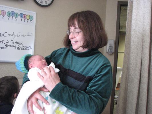 Grandma holds the new baby.