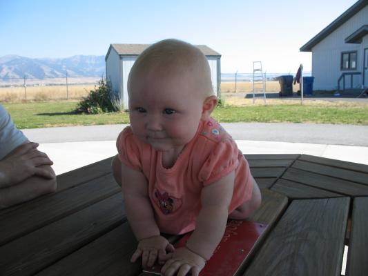 Sarah sits on the table.