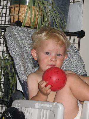 Noah sits in a high chair.