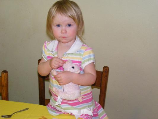 Sarah feeds her baby pig some chips