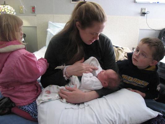 Sarah and Noah look at Joshua.