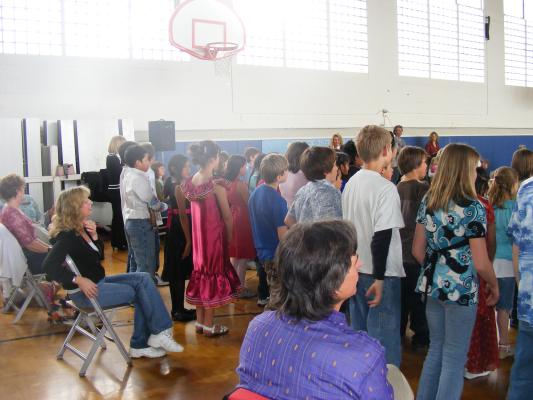 Malia (in red) sings with her class on international day.
